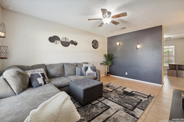 5311 Light House, San Antonio, TX 78242 - living room featuring a ceiling fan, light tile patterned floors, and a textured ceiling