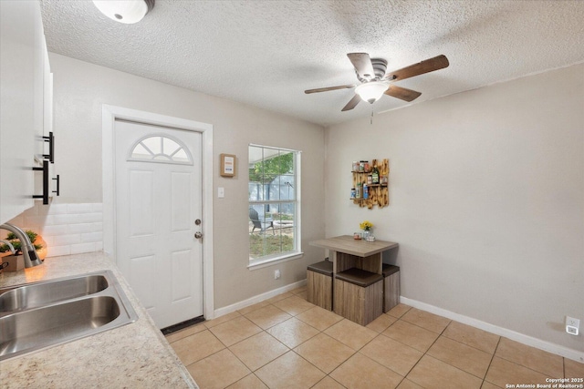 5311 Light House, San Antonio, TX 78242 - kitchen with a ceiling fan, light countertops, light tile patterned floors, decorative backsplash, and a textured ceiling