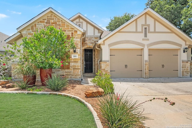 101 Boulder Crk, Boerne, TX 78006 - tudor home with stone siding, a garage, concrete driveway, and stucco siding