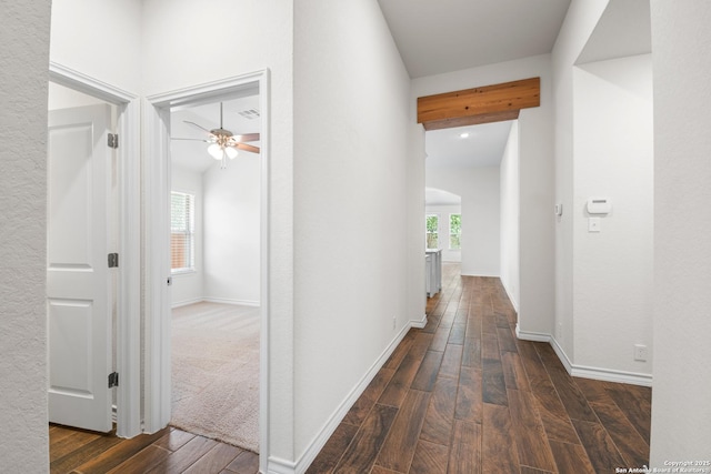 101 Boulder Crk, Boerne, TX 78006 - hallway with plenty of natural light, dark wood finished floors, and arched walkways
