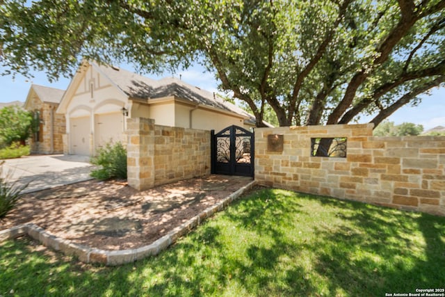 101 Boulder Crk, Boerne, TX 78006 - view of front of property with stucco siding, a gate, concrete driveway, stone siding, and a garage