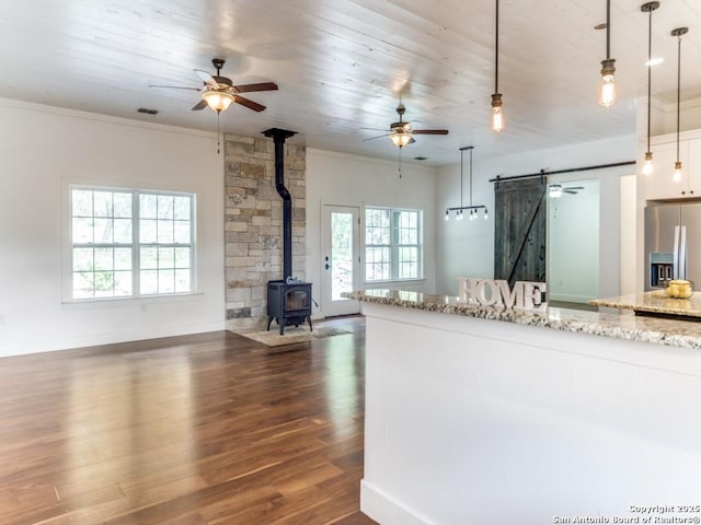 2521 Bay Hl, Bulverde, TX 78163 - kitchen with a barn door, a ceiling fan, open floor plan, stainless steel fridge, and crown molding