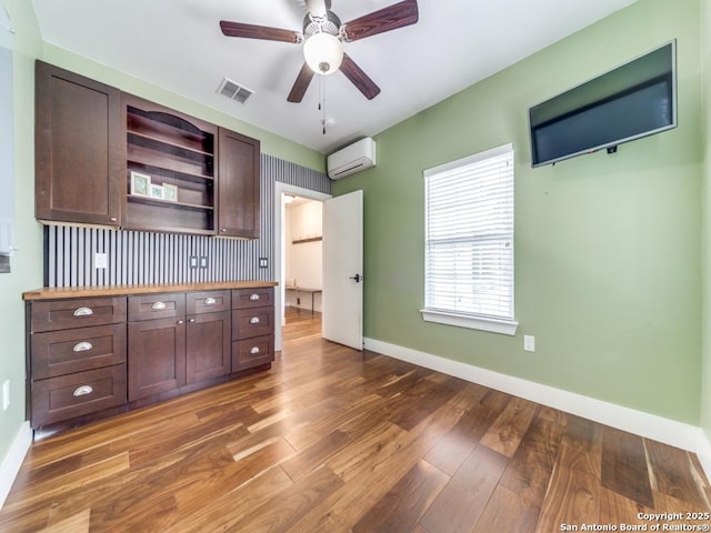 2521 Bay Hl, Bulverde, TX 78163 - unfurnished bedroom featuring an AC wall unit and wood finished floors