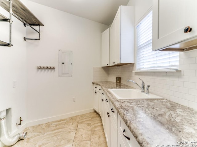 2521 Bay Hl, Bulverde, TX 78163 - kitchen with electric panel, healthy amount of natural light, backsplash, and white cabinets