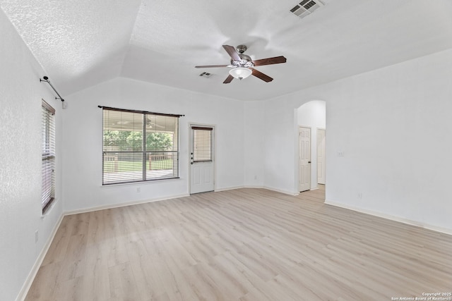 153 Bison Ln, Cibolo, TX 78108 - spare room featuring ceiling fan, light wood-type flooring, arched walkways, and lofted ceiling