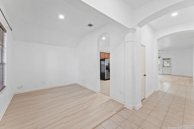 153 Bison Ln, Cibolo, TX 78108 - empty room featuring arched walkways, light wood finished floors, recessed lighting, and lofted ceiling