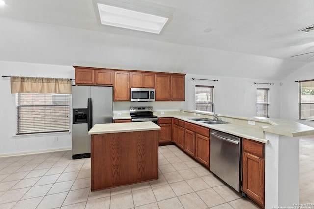 153 Bison Ln, Cibolo, TX 78108 - kitchen featuring appliances with stainless steel finishes, vaulted ceiling, a peninsula, light countertops, and light tile patterned floors