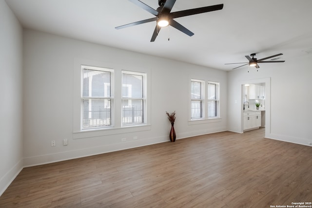 1002 Aganier, San Antonio, TX 78212 - unfurnished living room with ceiling fan and light wood-style flooring