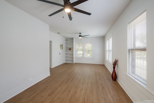 1002 Aganier, San Antonio, TX 78212 - empty room with a ceiling fan, light wood-style floors, and built in features