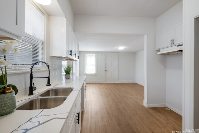 1002 Aganier, San Antonio, TX 78212 - kitchen featuring light wood-style flooring, white cabinetry, light stone counters, and tasteful backsplash