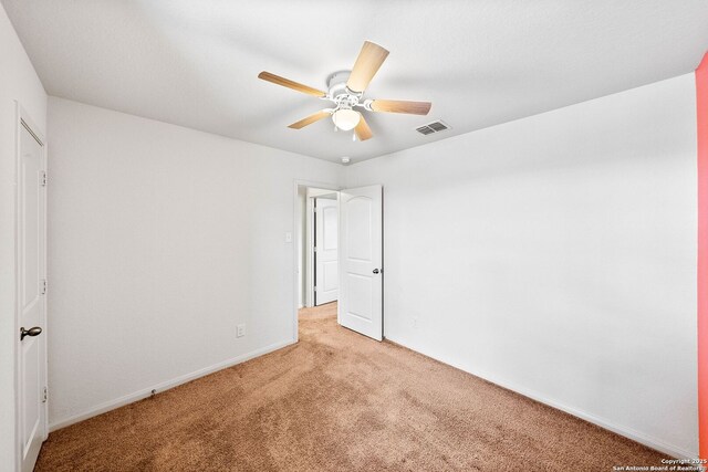 3827 Southton Vw, San Antonio, TX 78222 - unfurnished bedroom featuring light colored carpet and a ceiling fan