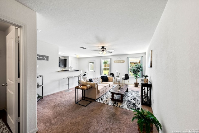 3827 Southton Vw, San Antonio, TX 78222 - carpeted living area with ceiling fan and a textured ceiling
