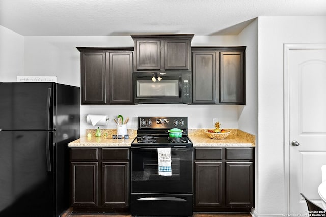 3827 Southton Vw, San Antonio, TX 78222 - kitchen featuring black appliances, dark brown cabinetry, wood finished floors, and light stone counters