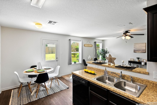 3827 Southton Vw, San Antonio, TX 78222 - kitchen featuring black dishwasher, a peninsula, dark wood finished floors, ceiling fan, and a textured ceiling