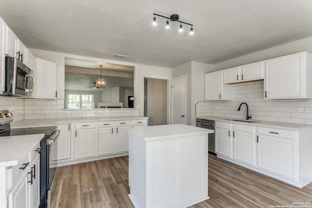 3311 Coral Grove, San Antonio, TX 78247 - kitchen with stainless steel appliances, light wood-style flooring, tasteful backsplash, and light countertops