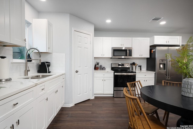 559 W Nacogdoches St, New Braunfels, TX 78130 - kitchen with stainless steel appliances, decorative backsplash, white cabinetry, and recessed lighting