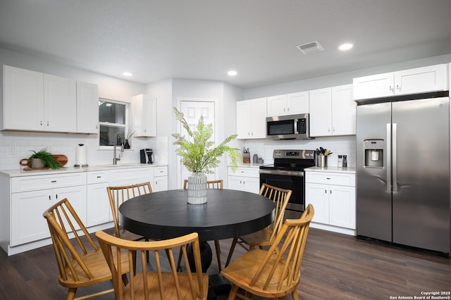 559 W Nacogdoches St, New Braunfels, TX 78130 - kitchen with stainless steel appliances, decorative backsplash, light countertops, white cabinets, and recessed lighting
