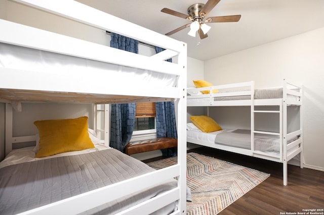 559 W Nacogdoches St, New Braunfels, TX 78130 - bedroom with wood finished floors, a fireplace, and a ceiling fan