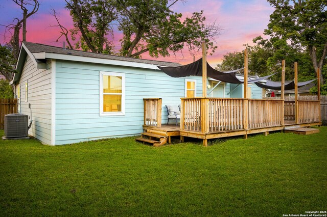 559 W Nacogdoches St, New Braunfels, TX 78130 - back of property at dusk with a deck