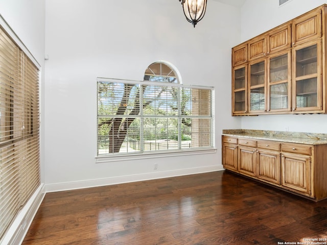 6 De Zavala, Shavano Park, TX 78231 - unfurnished dining area featuring a towering ceiling and dark wood-style floors