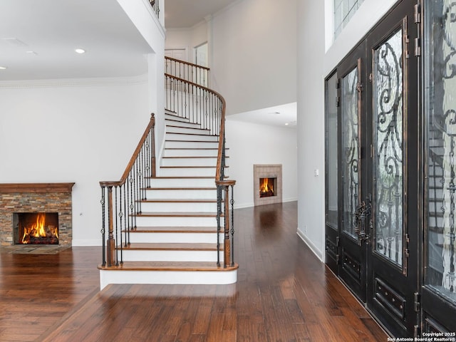 6 De Zavala, Shavano Park, TX 78231 - entrance foyer with a stone fireplace, a high ceiling, stairs, hardwood / wood-style flooring, and crown molding