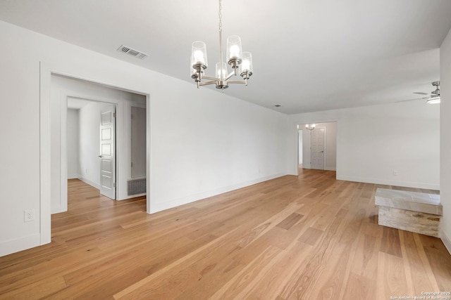 935 Spring Branch Rd, Spring Branch, TX 78070 - unfurnished room with a chandelier, light wood-style flooring, and a ceiling fan