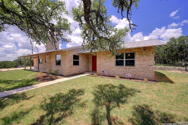 935 Spring Branch Rd, Spring Branch, TX 78070 - ranch-style home featuring stone siding, a standing seam roof, a front lawn, a chimney, and a patio area