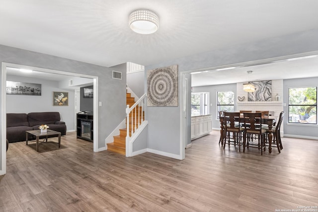 1654 Rob Roy, San Antonio, TX 78251 - dining area with stairs, wood finished floors, and a brick fireplace