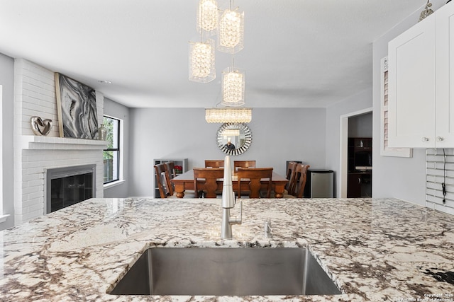 1654 Rob Roy, San Antonio, TX 78251 - kitchen featuring a chandelier, light stone counters, and hanging light fixtures