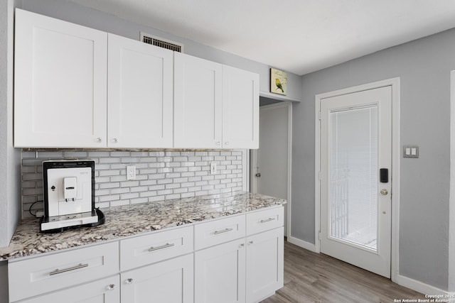 1654 Rob Roy, San Antonio, TX 78251 - kitchen featuring tasteful backsplash, light wood-style flooring, and white cabinetry