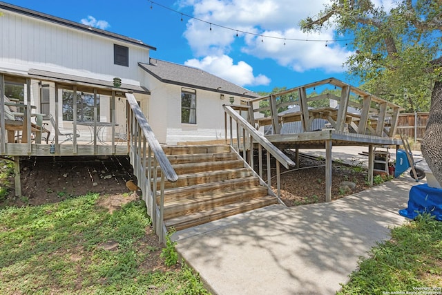 1654 Rob Roy, San Antonio, TX 78251 - rear view of house featuring brick siding, a deck, roof with shingles, and stairs
