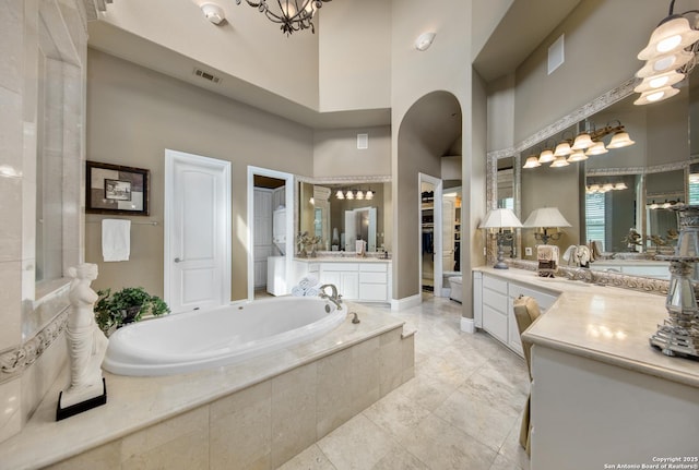 2 Admirals Way, San Antonio, TX 78257 - full bathroom with a high ceiling, a bath, vanity, a chandelier, and tile patterned floors