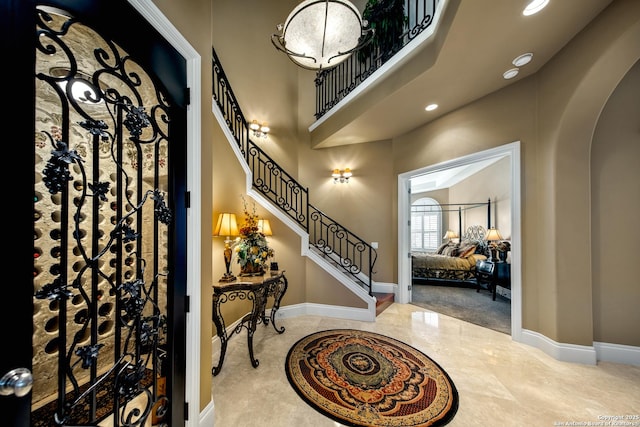 2 Admirals Way, San Antonio, TX 78257 - foyer entrance with arched walkways, recessed lighting, marble tiled floors, a high ceiling, and stairs