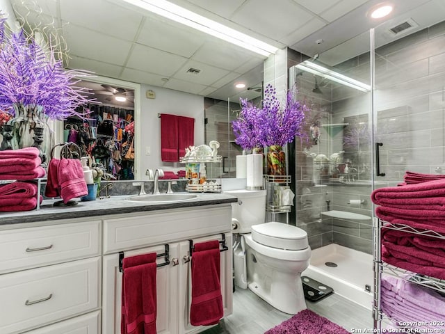 1 Towers Park Unit 211, San Antonio, TX 78209 - full bathroom featuring vanity, a stall shower, a paneled ceiling, and wood finished floors