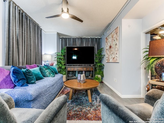 1 Towers Park Unit 211, San Antonio, TX 78209 - living area with wood finished floors, ceiling fan, and a textured ceiling