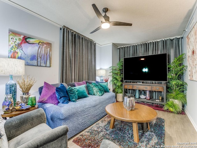 1 Towers Park Unit 211, San Antonio, TX 78209 - living room featuring a ceiling fan, wood finished floors, and a textured ceiling