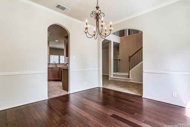 3501 Big Horn, Schertz, TX 78154 - empty room with arched walkways, wood finished floors, stairway, a chandelier, and ornamental molding