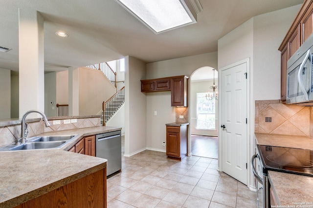 3501 Big Horn, Schertz, TX 78154 - kitchen featuring appliances with stainless steel finishes, backsplash, plenty of natural light, brown cabinetry, and recessed lighting