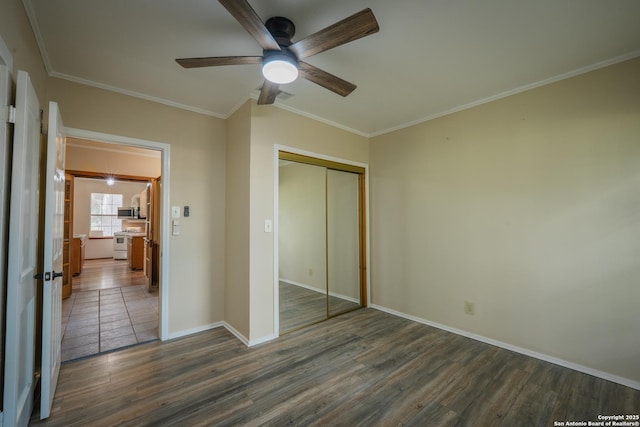 9071 Fm 725, Mcqueeney, TX 78123 - unfurnished bedroom with dark wood-style flooring, a closet, ornamental molding, and ceiling fan