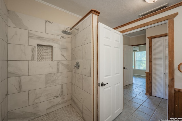 9071 Fm 725, Mcqueeney, TX 78123 - full bath featuring tiled shower, a wall mounted AC, ornamental molding, tile patterned floors, and a closet
