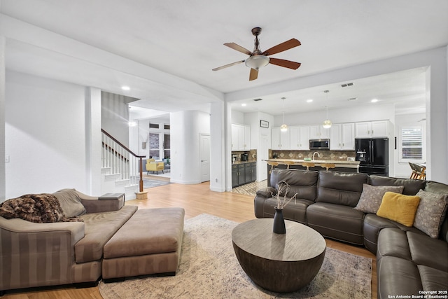 1162 Thunder Cloud, Spring Branch, TX 78070 - living area with light wood-style flooring, a ceiling fan, stairway, and recessed lighting