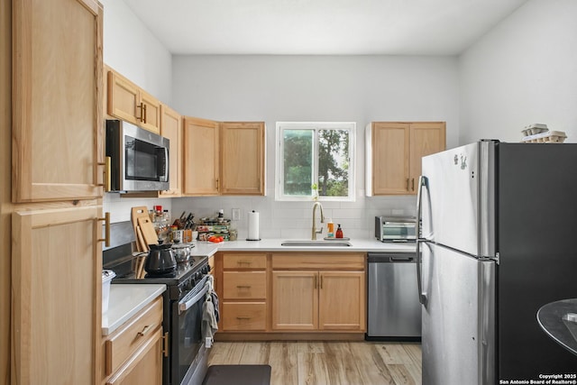 1162 Thunder Cloud, Spring Branch, TX 78070 - kitchen with appliances with stainless steel finishes, light brown cabinets, light countertops, tasteful backsplash, and light wood-style floors