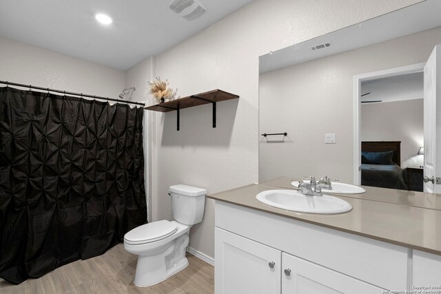 6041 Vestige Bnd, Bulverde, TX 78163 - ensuite bathroom with wood finished floors, vanity, and curtained shower