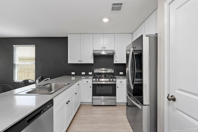 6041 Vestige Bnd, Bulverde, TX 78163 - kitchen featuring appliances with stainless steel finishes, under cabinet range hood, white cabinetry, and recessed lighting