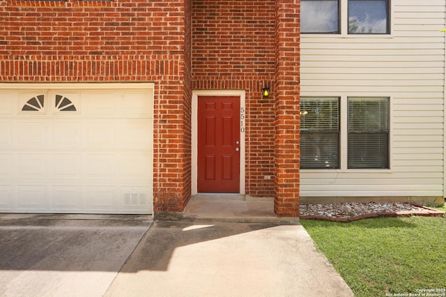 5510 Camry Spgs, San Antonio, TX 78251 - view of exterior entry with brick siding, driveway, and an attached garage