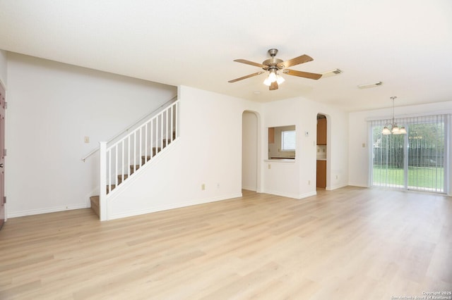 5510 Camry Spgs, San Antonio, TX 78251 - unfurnished living room featuring light wood finished floors, stairs, arched walkways, a chandelier, and a ceiling fan