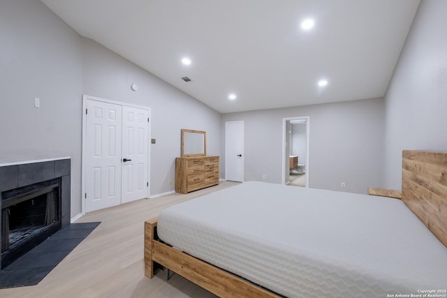 16738 Stoney Glade, San Antonio, TX 78247 - bedroom with light wood-style floors, recessed lighting, a tiled fireplace, lofted ceiling, and ensuite bathroom