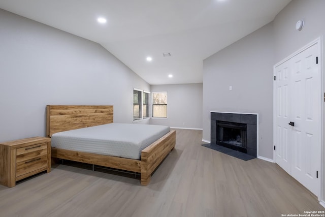 16738 Stoney Glade, San Antonio, TX 78247 - bedroom with wood finished floors, vaulted ceiling, recessed lighting, and a tiled fireplace