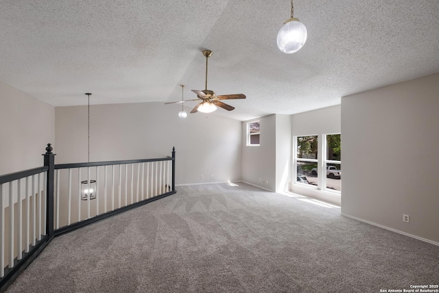 16738 Stoney Glade, San Antonio, TX 78247 - spare room featuring a ceiling fan, carpet floors, vaulted ceiling, and a textured ceiling