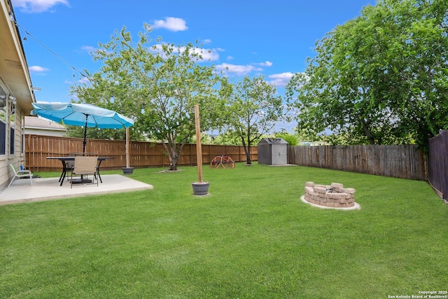 6206 Heathers Cv, San Antonio, TX 78227 - fenced backyard featuring a fire pit, a patio area, and a storage unit